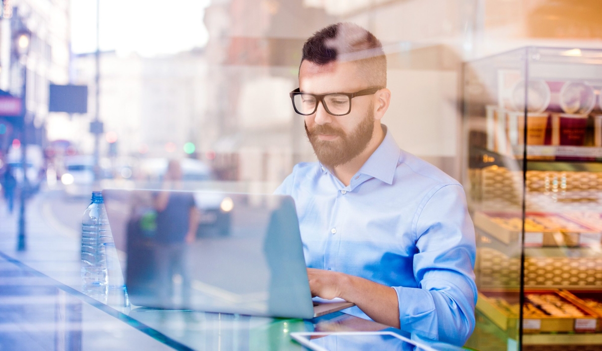 demo-attachment-146-Hipster-manager-in-cafe-working-on-laptop-by-window